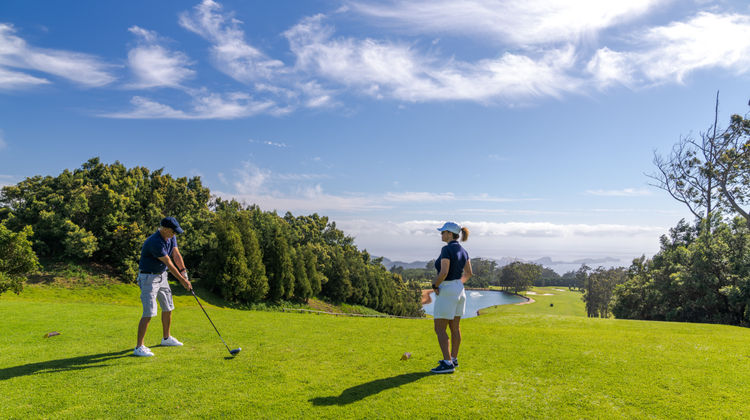 Golfers preparing to tee off at Santo da Serra Golf Course with ocean views in Madeira Island