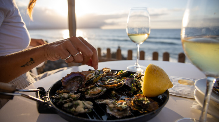 Traditional grilled limpets with lemon and white wine by the sea in São Miguel.