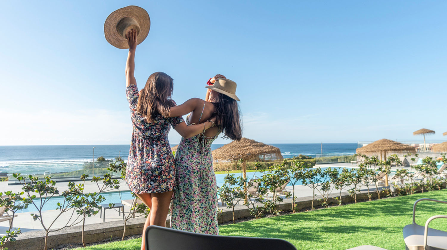 Woman and child overlooking the ocean from the outdoor infinity pool at Hotel Verde Mar & Spa on the north coast of São Miguel Island.