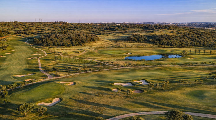 Aerial shot of Morgado Golf & Country Club, showcasing the lush fairways, greens, and surrounding Algarve countryside.