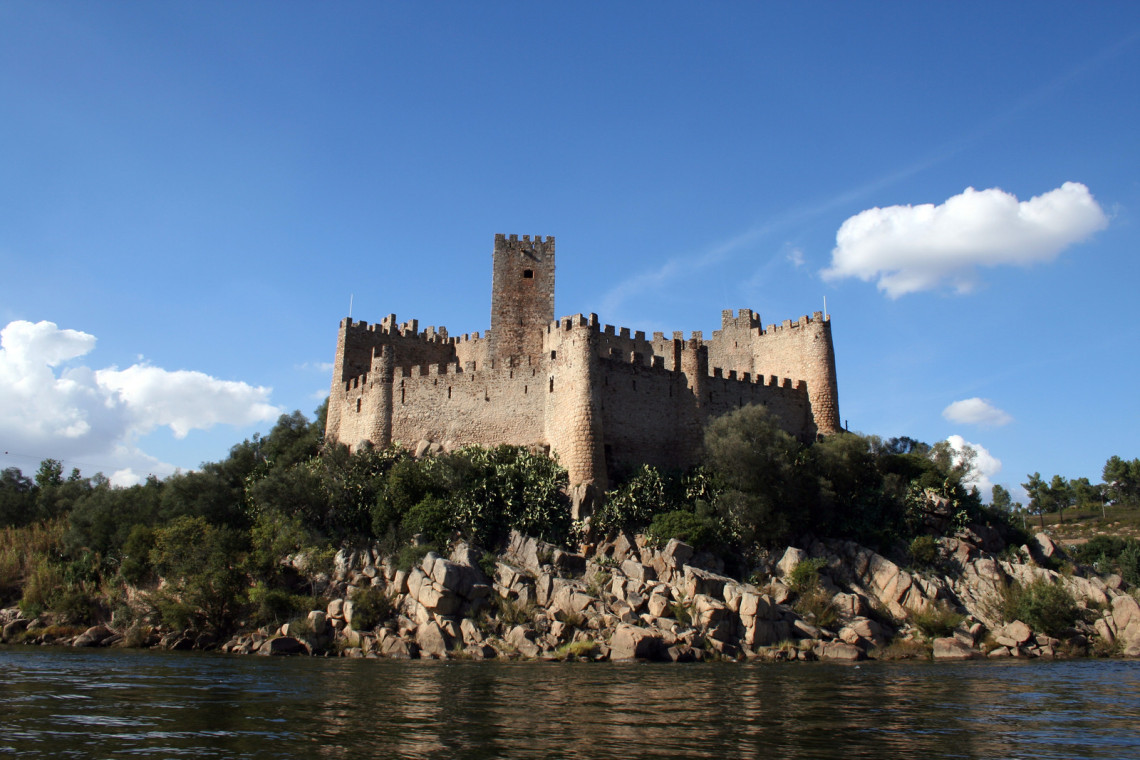 Almourol Castle in Portugal Almourol Castle and its reflection in the water of the Tejo River, Portugal.