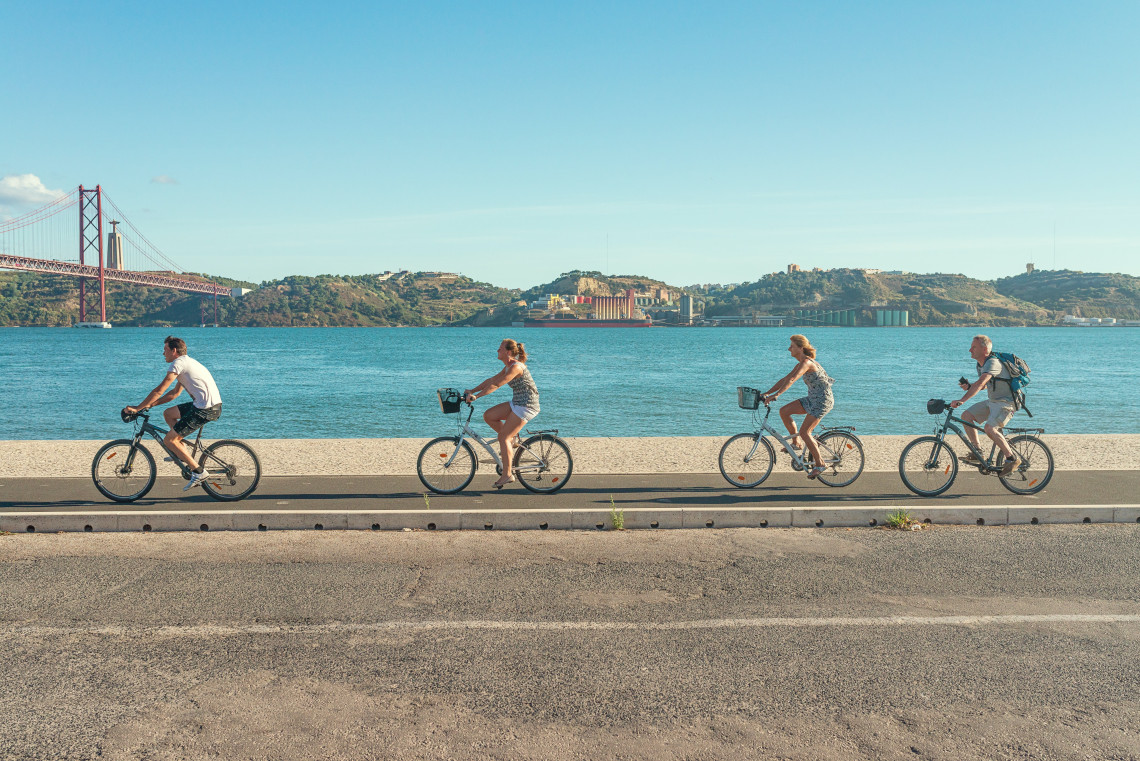 Cyclists exploring Lisbon's picturesque streets and landmarks on a bike tour.