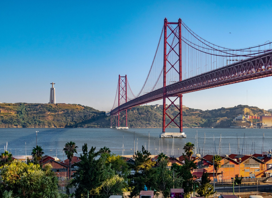 The iconic 25 de Abril Bridge over the Tagus River, with panoramic views of Lisbon's stunning landscape in Portugal.