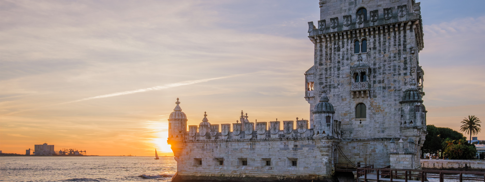 Belém Tower at sunset on the Tagus River in Lisbon, Portugal, a must-see landmark often featured in Lisbon Black Friday travel deals and vacation packages.