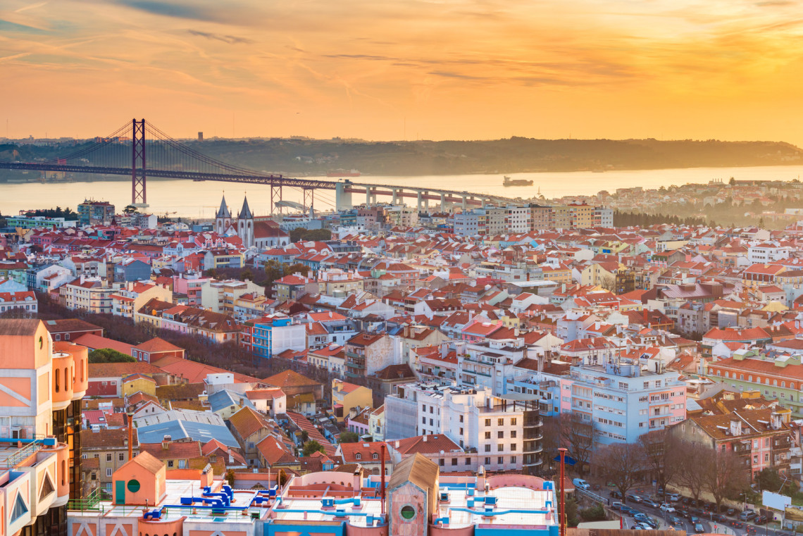 Beautiful sunset over Lisbon, Portugal. Evening cityscape, aerial panorama