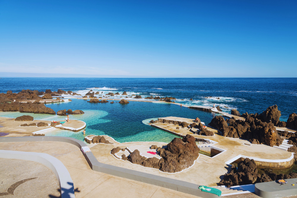 Porto Moniz Natural Pools – Volcanic Coast Experience in Madeira Island Natural volcanic swimming pools of Porto Moniz on the north coast of Madeira Island, Portugal, with clear blue Atlantic Ocean views