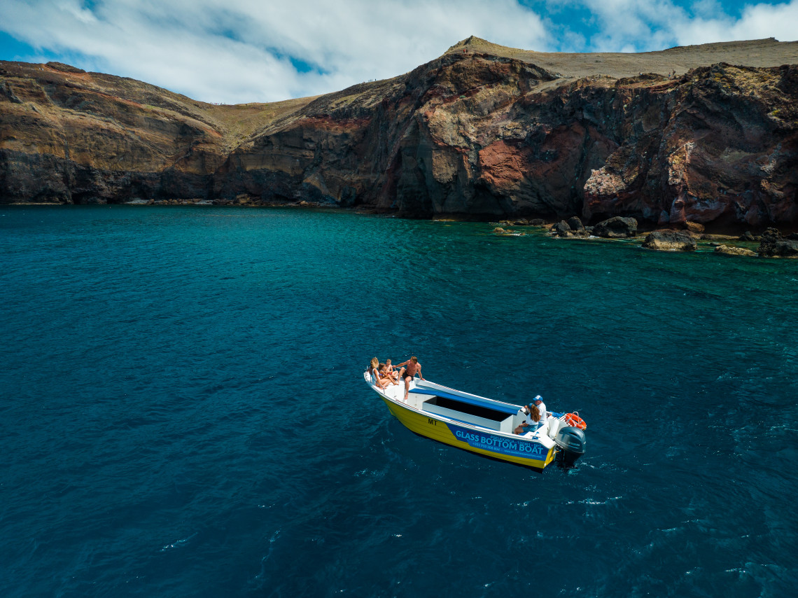 Madeira Island Boat Tour – Glass-Bottom Experience by the Cliffs Glass-bottom boat tour along the rocky coastline of Madeira Island, Portugal, with crystal-clear Atlantic waters and scenic cliffs
