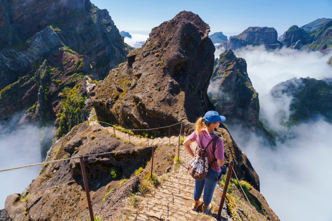 Hiker on PR1 Pico do Arieiro - Pico Ruivo trail Stairway to Heaven Madeira Portugal Hiker on PR1 Pico do Arieiro - Pico Ruivo trail Stairway to Heaven Madeira Portugal