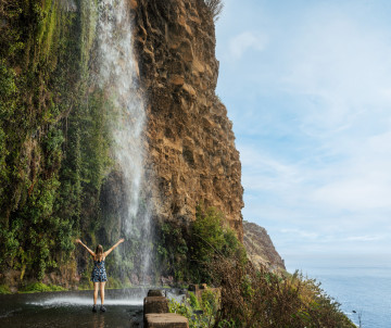 Woman in Anjos Waterfall in Madeira Island, Portugal