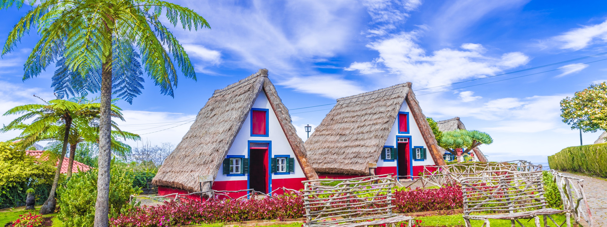 Traditional thatched Santana houses in Madeira, Portugal, a must-see cultural highlight.