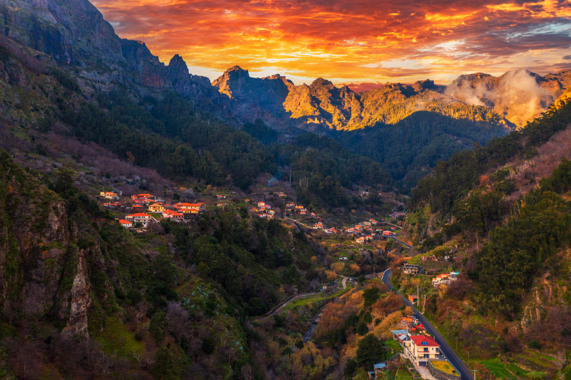 Colorful sunset above Curral Das Freiras village also known as the Nuns Valley surrounded by high mountains in the Madeira Islands, Portugal.