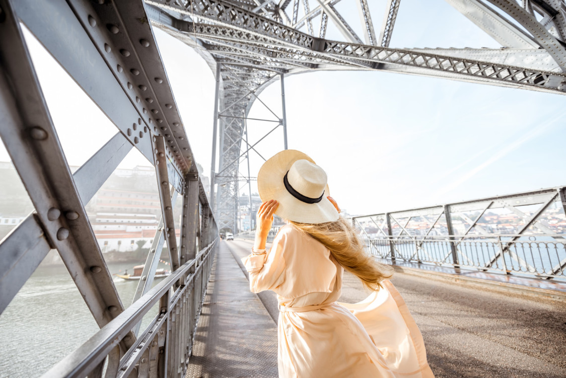 Don Luís I Bridge in Porto, Portugal young-woman-tourist-in-metal-bridge-of-porto-city-don-luis-portugal
