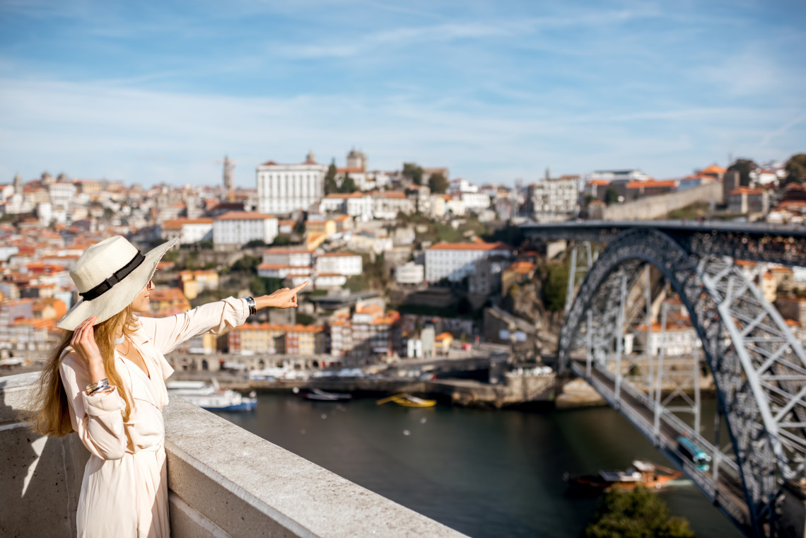 Traveler enjoying one of the best views in Porto, overlooking the Dom Luís I Bridge and the colorful Ribeira district.