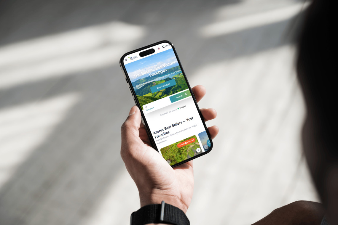 Traveler using a smartphone to browse Azores Getaways vacation packages online, highlighting convenience and trust in booking.