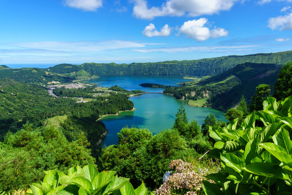 Sete Cidades Lake View, São Miguel Island, Azores A panoramic view of the twin lakes of Sete Cidades, surrounded by lush volcanic landscape on São Miguel Island, Azores, a top destination for group tours and sightseeing.