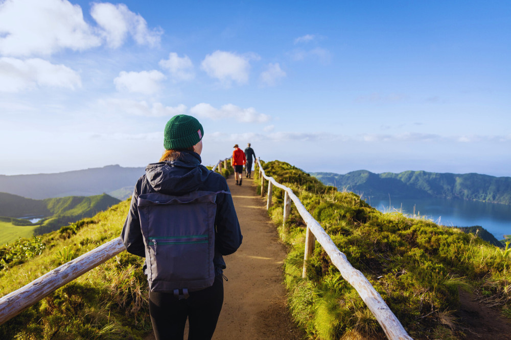 Hiking Trail with Scenic Views of Lagoa do Fogo, São Miguel Island Group of hikers walking along a scenic trail overlooking Lagoa do Fogo in São Miguel, Azores
