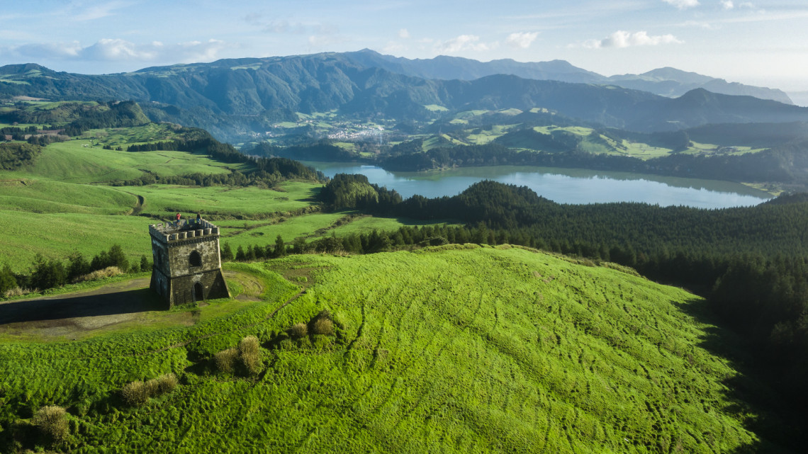 Castelo Branco Viewpoint in Ponta Garça – Scenic Tower Overlooking São Miguel’s Southern Coast Aerial view of Castelo Branco Viewpoint and its iconic tower in Ponta Garça, São Miguel Island, overlooking the lush green hills and coastline of the Azores.