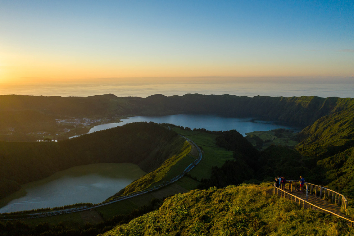 Boca do Inferno Lookout Overlooking Sete Cidades Lakes at Sunset, São Miguel, Azores Aerial view of Boca do Inferno lookout at sunset in Sete Cidades, with visitors enjoying the sweeping view of Sete Cidades' twin crater lakes and lush green caldera