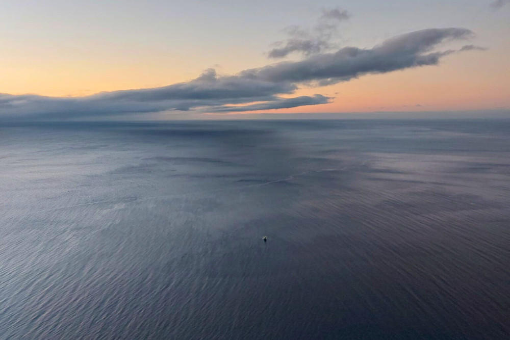 Sunrise at Ponta da Madrugada Viewpoint in São Miguel, Azores Golden sunrise over the Atlantic Ocean seen from Ponta da Madrugada viewpoint in São Miguel Island, Azores, with soft clouds and calm sea