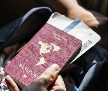 ETIAS Portugal and Azores travel requirements – Passport and boarding pass Traveler holding a passport and boarding pass, preparing for a trip to Portugal or the Azores under the new ETIAS travel authorisation rules