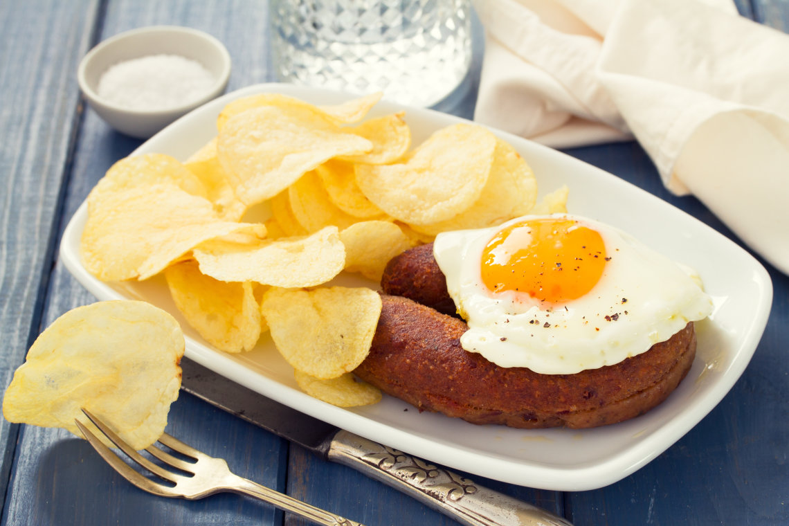 Alheira de la isla de Santa María, Azores Fried portuguese sausage alheira with egg and potato chips to try on your azores vacations