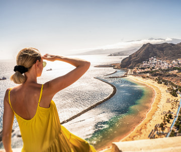 Landscape of Las Teresitas beach and San Andres village, Tenerife, Canary Islands, Spain. amazing-place-to-visit-woman-looking-at-the-landscape-of-las-teresitas-beach-and-san-andres-village-tenerife-canary-islands-spain