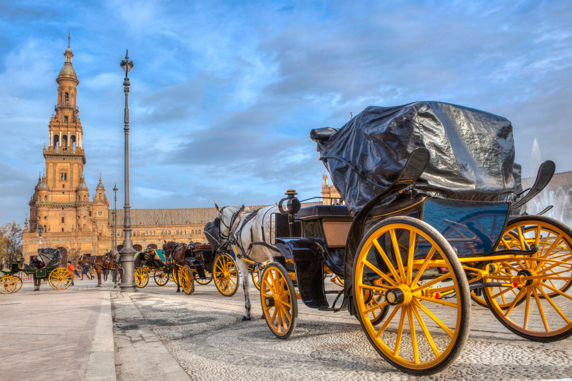 Horse carriages in Plaza de Espana, Seville, Spain horse-carriages-in-plaza-de-espana-at-sunset